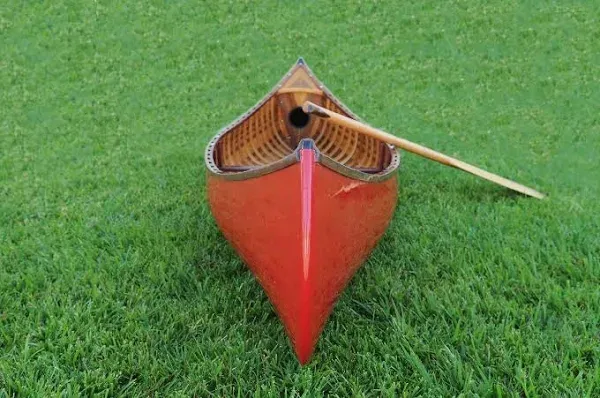 Red Wooden Canoe with Ribs and Curved Bow